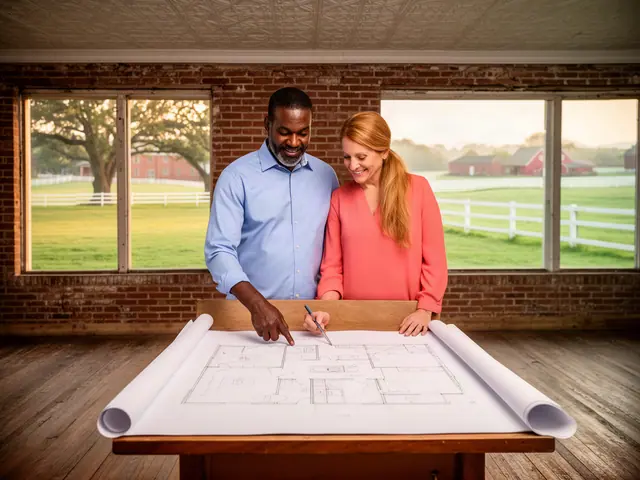 Two business partners looking over a pencil floor sketch in an empty storefront.